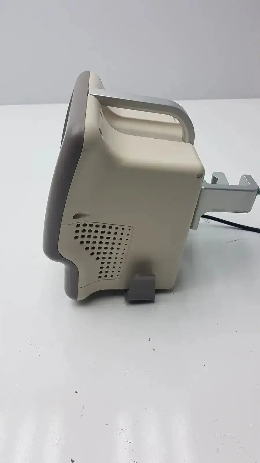 Beige and gray plastic vasamed sensilase pressure testing monitor with perforated vent panel on the back side