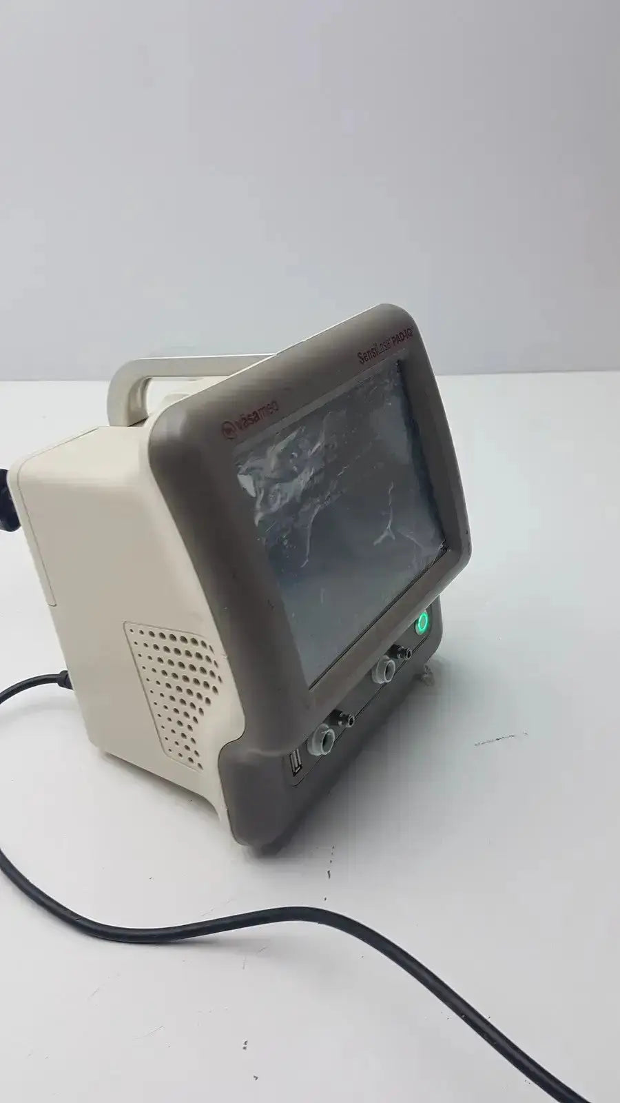Beige and gray vasamed sensilase pressure testing monitor with small screen ventilation grille and control knobs