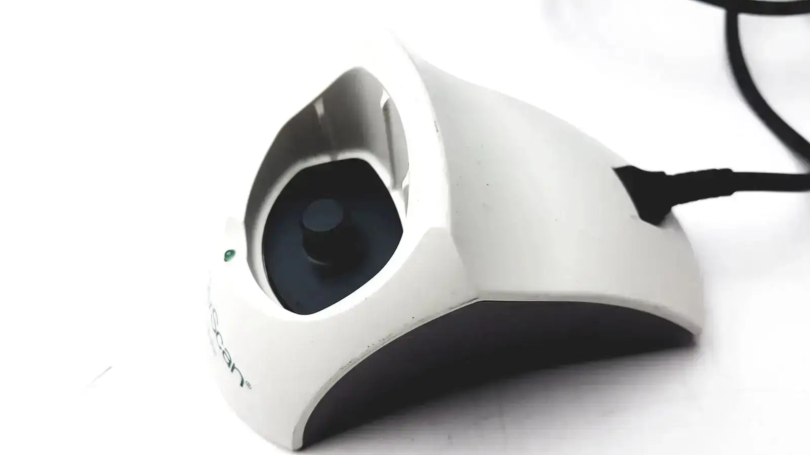 White and black ergonomic mouse with curved design and logitech branding used with bladderscan charging cradle