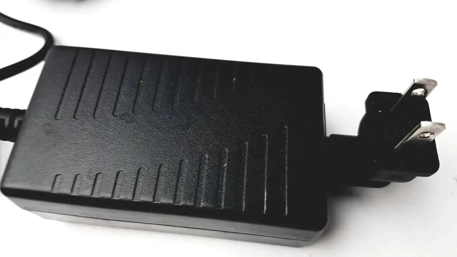 Black plastic textured power adapter with two-prong plug for verathon 0570-0155 bladderscan charging cradle