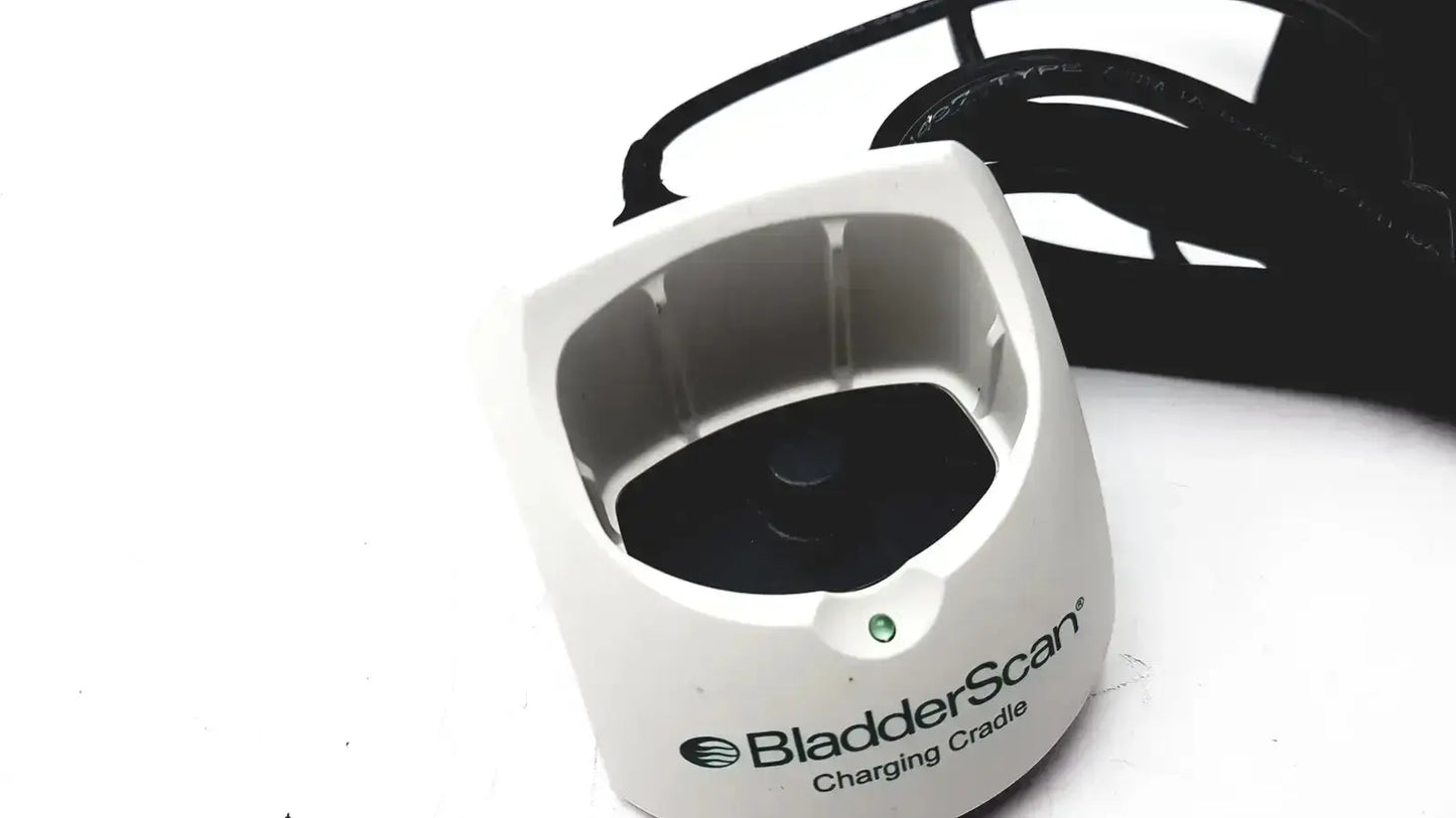 White plastic Verathon 0570-0155 bladderscan charging cradle with black interior and green indicator light for charging