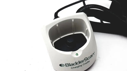 White plastic Verathon 0570-0155 bladderscan charging cradle with black interior and green indicator light for charging