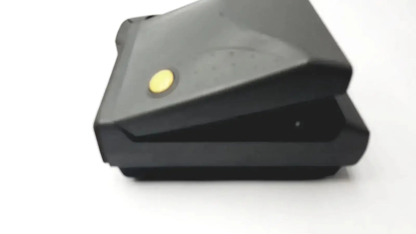 Black plastic vintage polaroid spectra 2 instant film camera featuring a yellow circular button on top surface untested