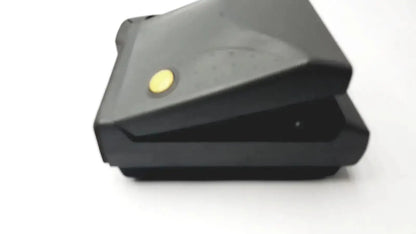 Black plastic vintage polaroid spectra 2 instant film camera featuring a yellow circular button on top surface untested