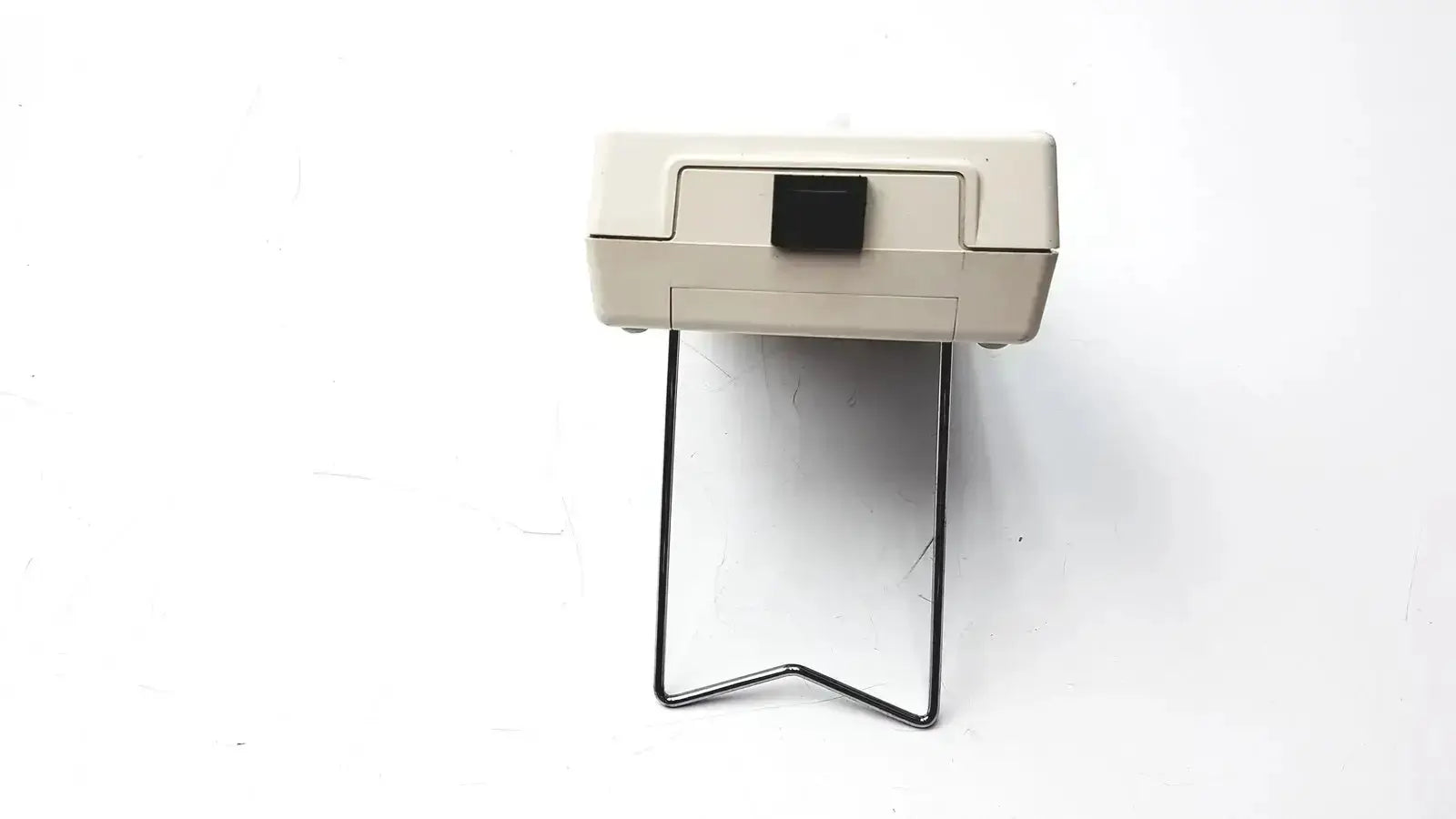 Beige plastic vitalograph breathco carbon monoxide monitor with black button and metal stand for smoking cessation use