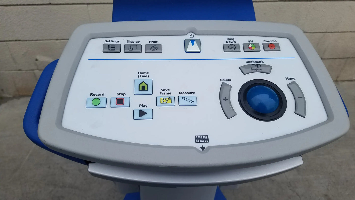 Blue and gray control panel with central blue trackball and labeled buttons on Volcano S5 intravascular ultrasound medical equipment