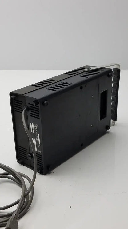 Black rectangular volpi intralux 6000 light source with ventilation slots and coiled power cable 115v 185w back view