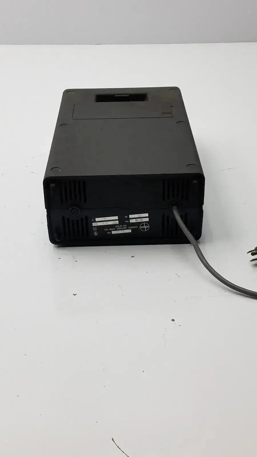 Black rectangular volpi intralux 6000 light source power supply unit with ventilation slots and gray cable 115v 185w