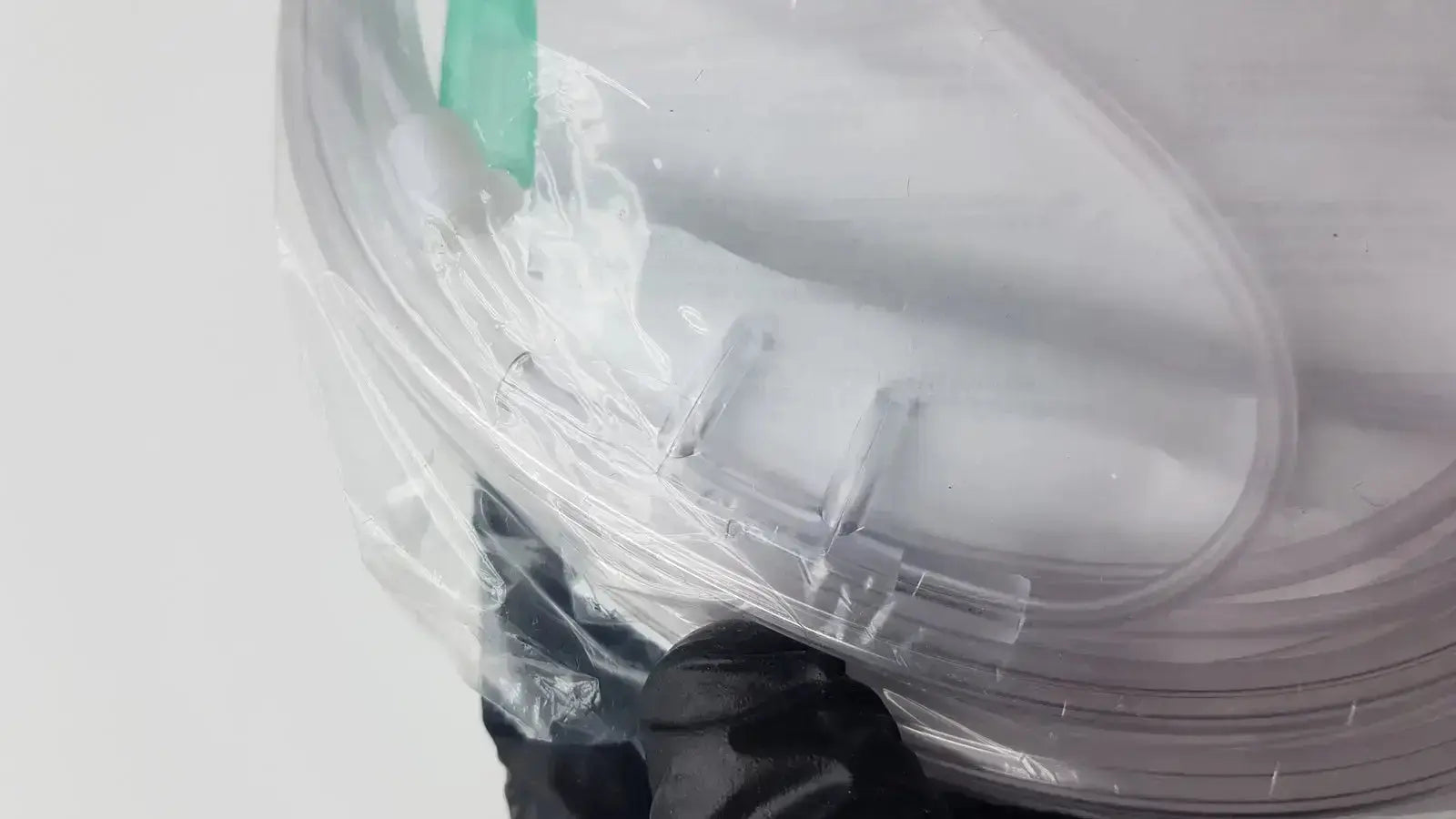 Clear plastic vyaire mask oxygen cannula with transparent tubing and green strap for medical oxygen delivery