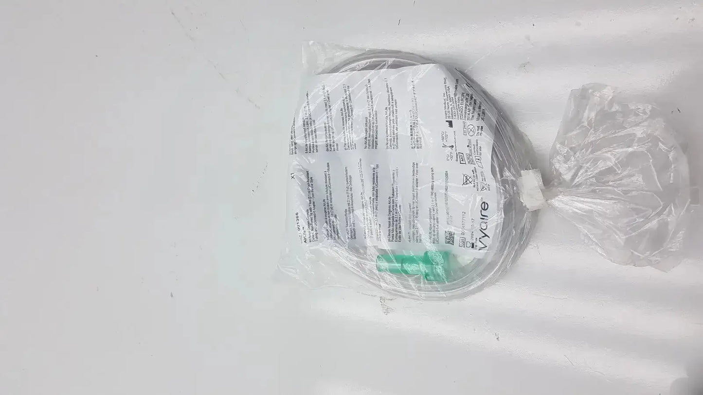 A coiled transparent oxygen cannula with green connector and printed instructions in clear plastic packaging for vyaire mask oxygen