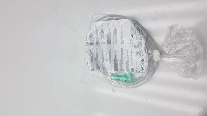 A coiled transparent oxygen cannula with green connector and printed instructions in clear plastic packaging for vyaire mask oxygen
