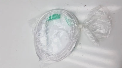 Clear plastic-wrapped oval container with green lid and tied end of vyaire mask oxygen cannula ref 001366