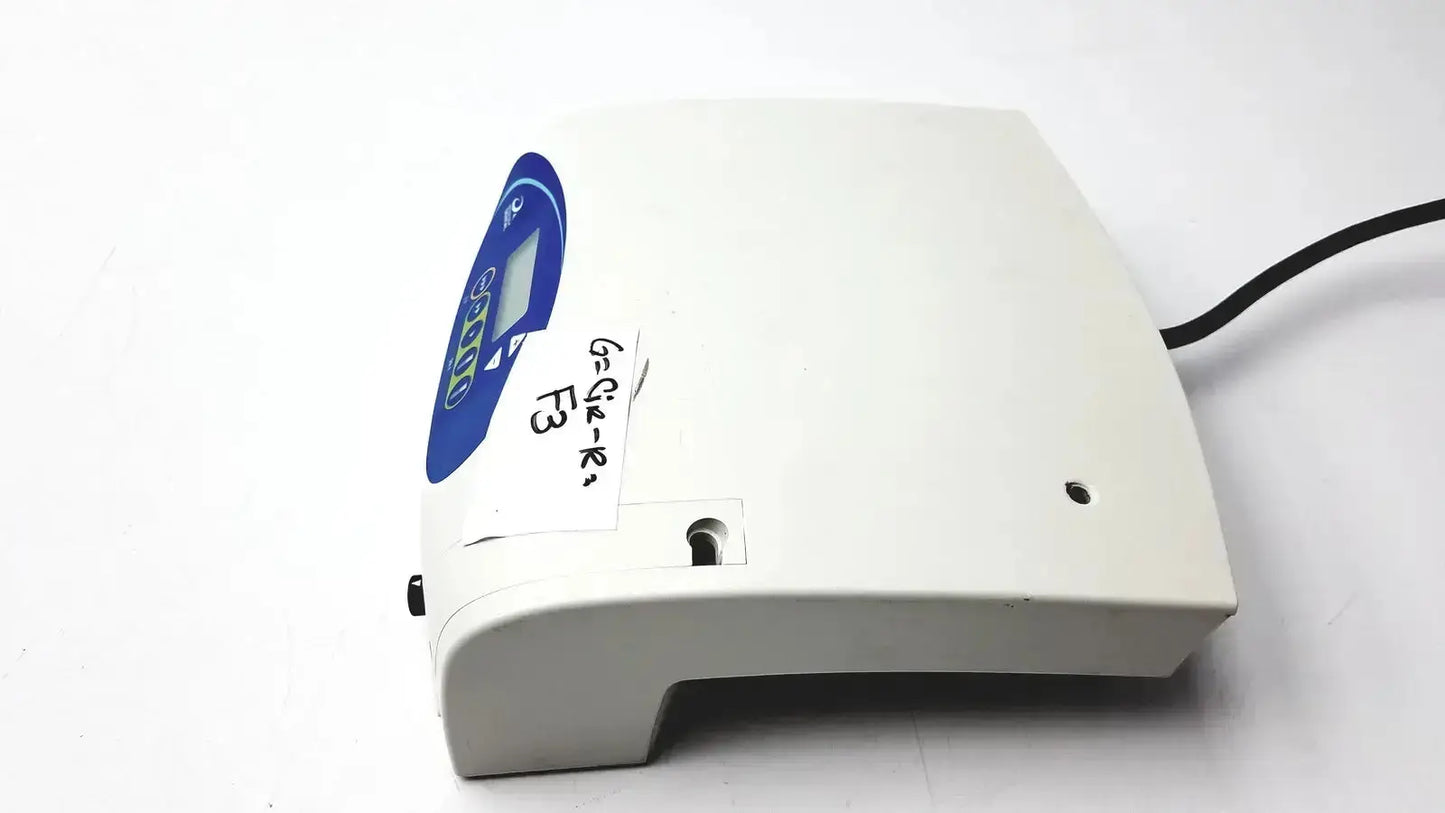 White plastic astra tech si-915 dental handpiece unit with blue circular display panel and handwritten label for medical use