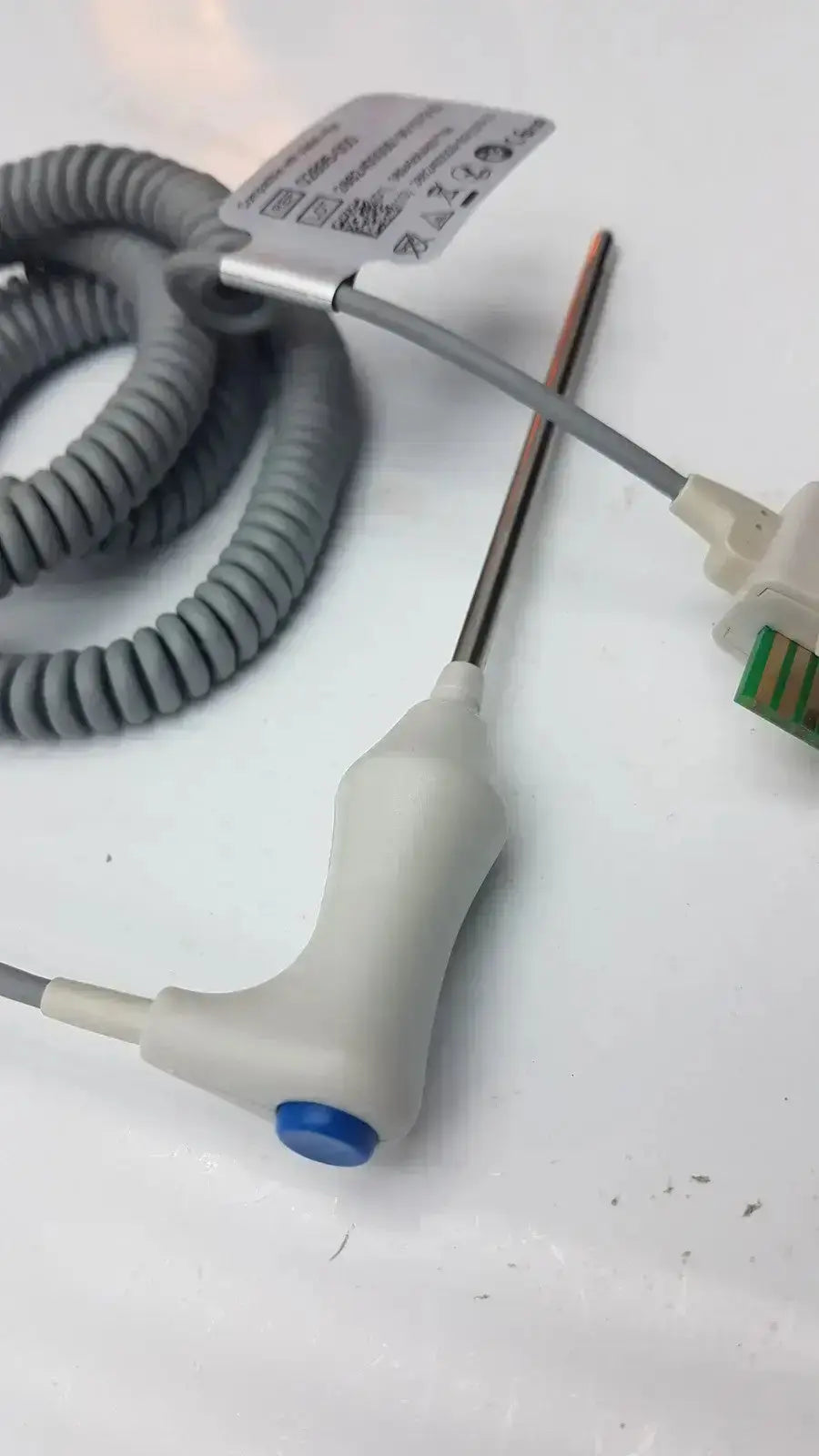 Gray coiled oral temperature probe with white handle and blue button connected to thin metallic Welch Allyn 02895-000 probe