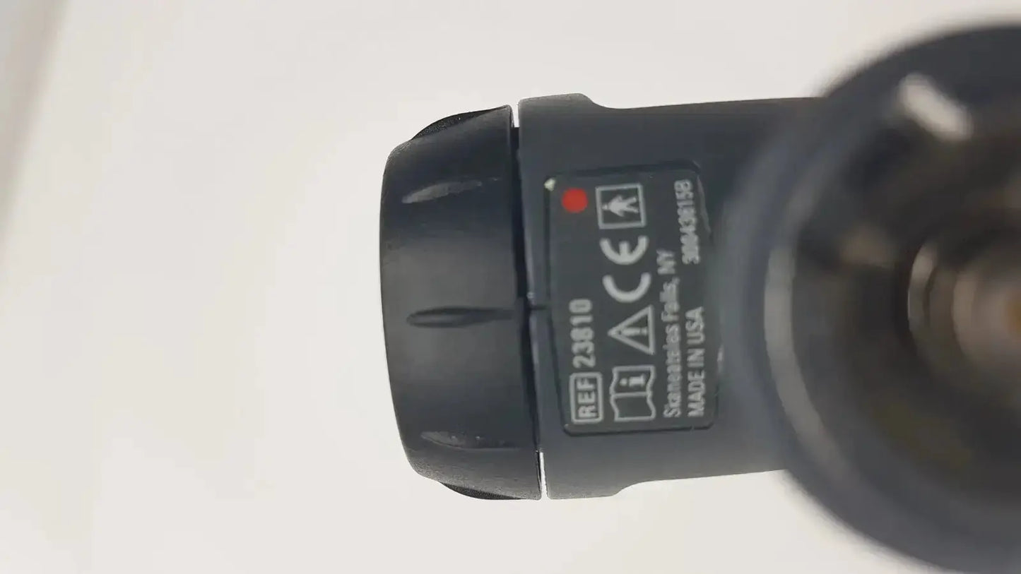 Black plastic flashlight head with textured grip and labeled specifications for welch allyn macroview otoscope ear speculums