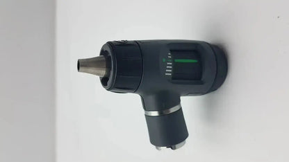 Black handheld welch allyn macroview otoscope with metallic tip and green illuminated scale for ear speculums use