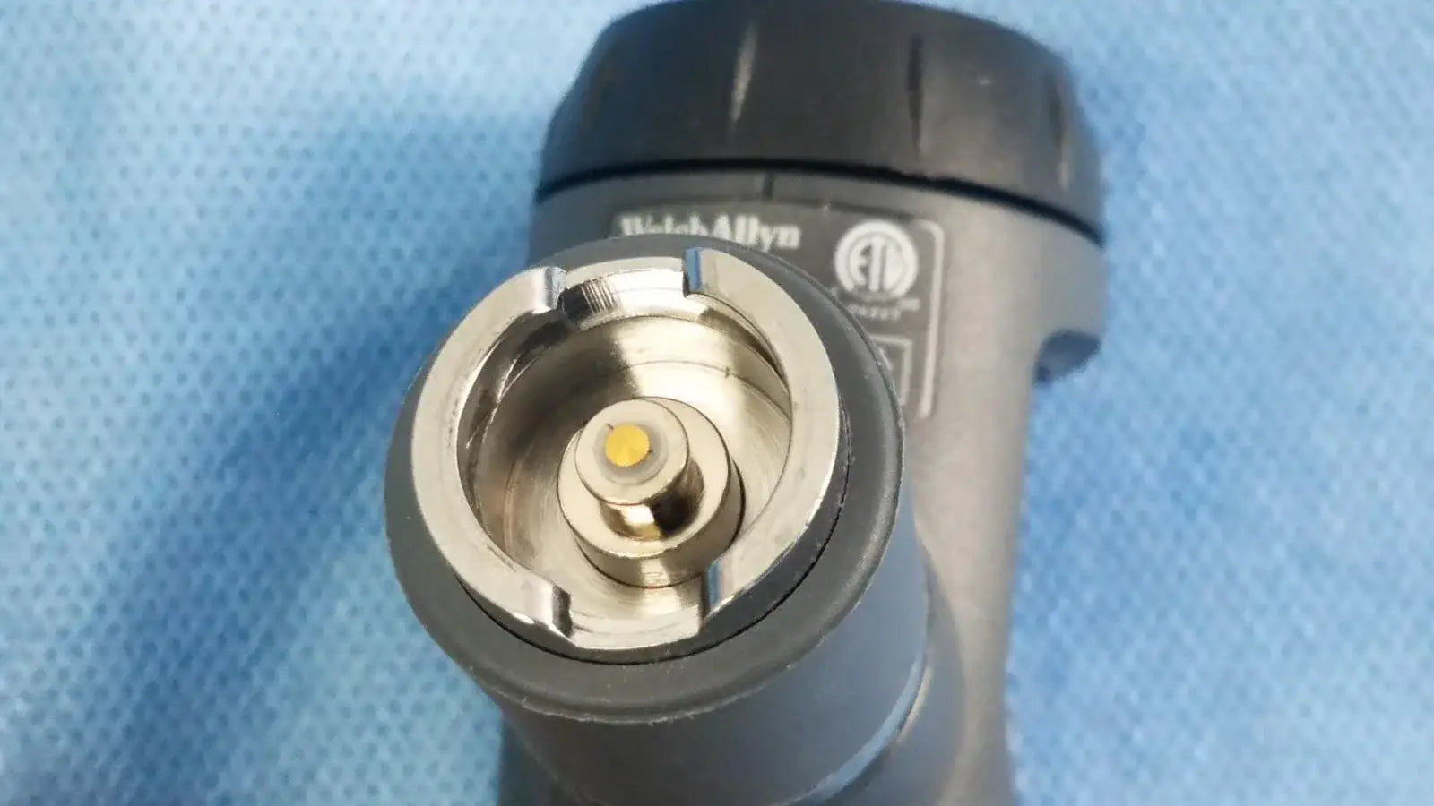 Black and silver textured grip flashlight part of welch allyn 23810 macroview 3.5v surecolor led fiber optic otoscope for medical equipment use