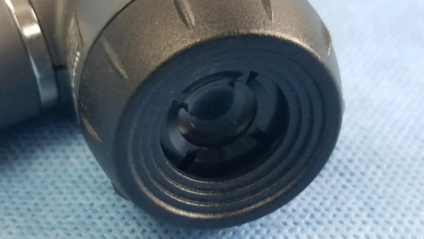 Black rubberized macroview otoscope lens with textured exterior and grooves for reuse medical equipment applications