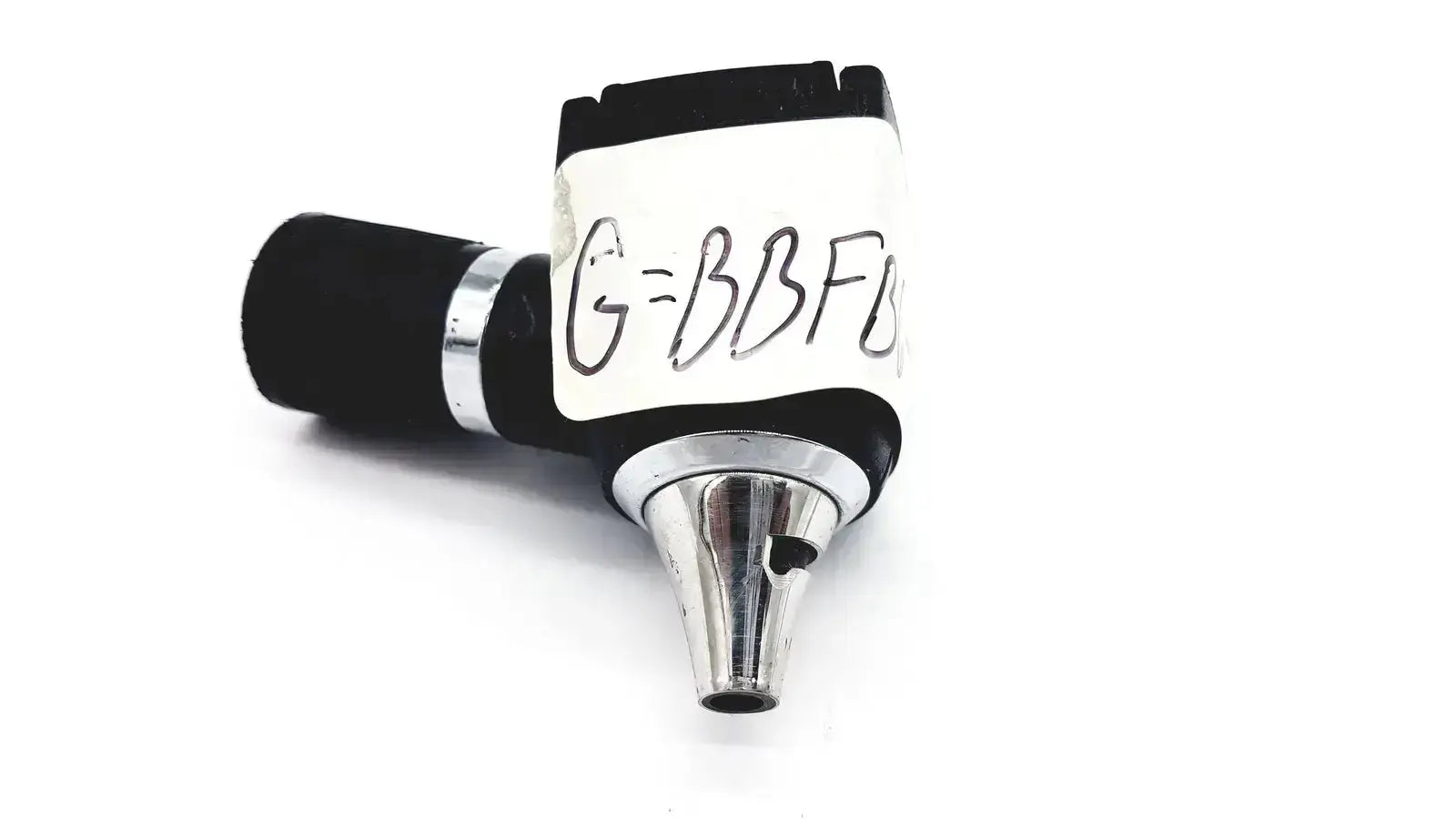 Black and silver Welch Allyn 25020 3.5V otoscope ophthalmoscope head with handwritten label on white adhesive strip