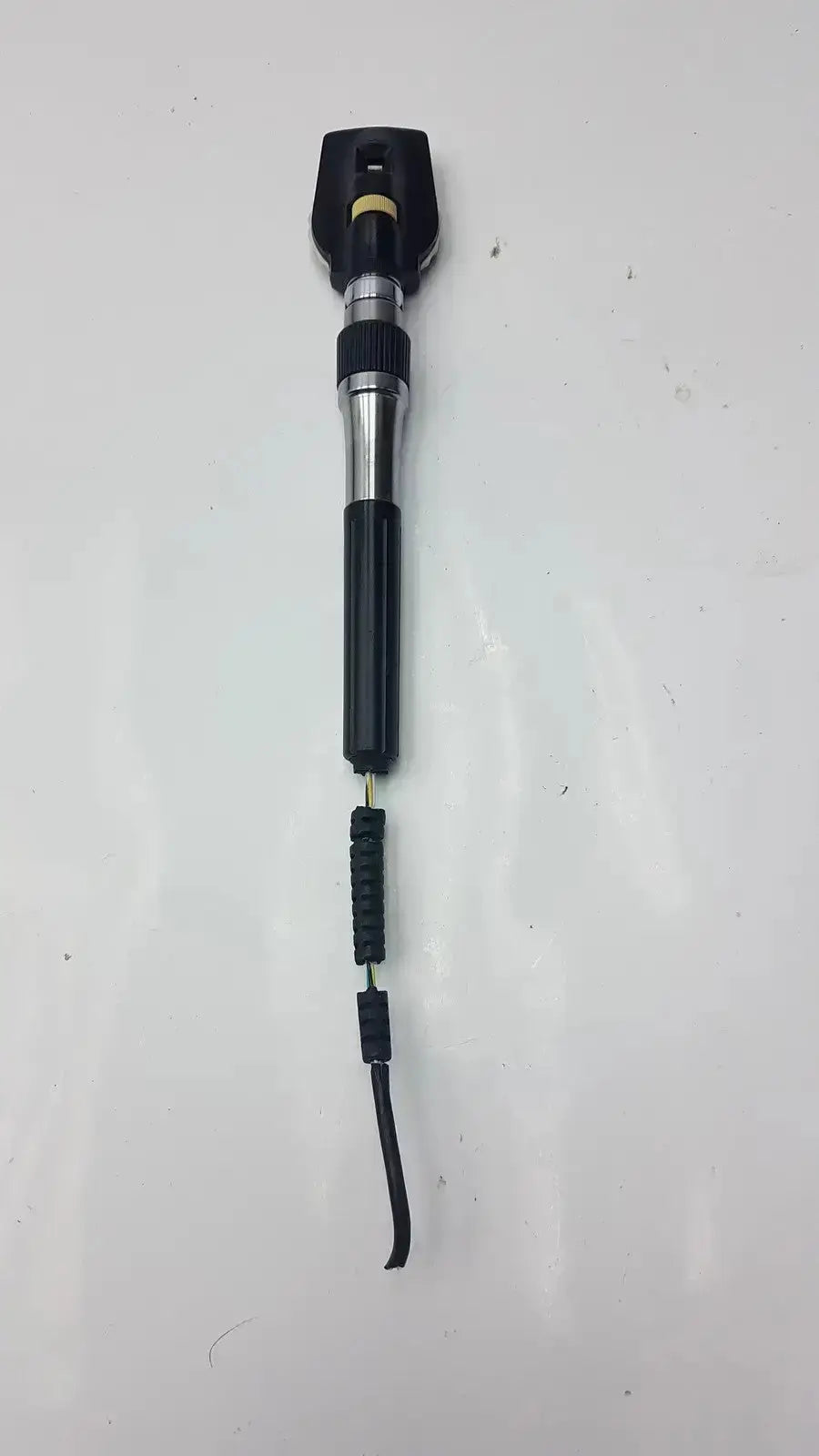 Black and silver welch allyn ophthalmoscope head with textured grip and flexible tip for hospital surplus medical exams