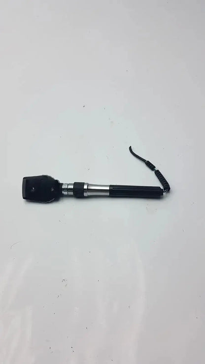 Black and silver welch allyn ophthalmoscope head with coiled black strap for hospital surplus use