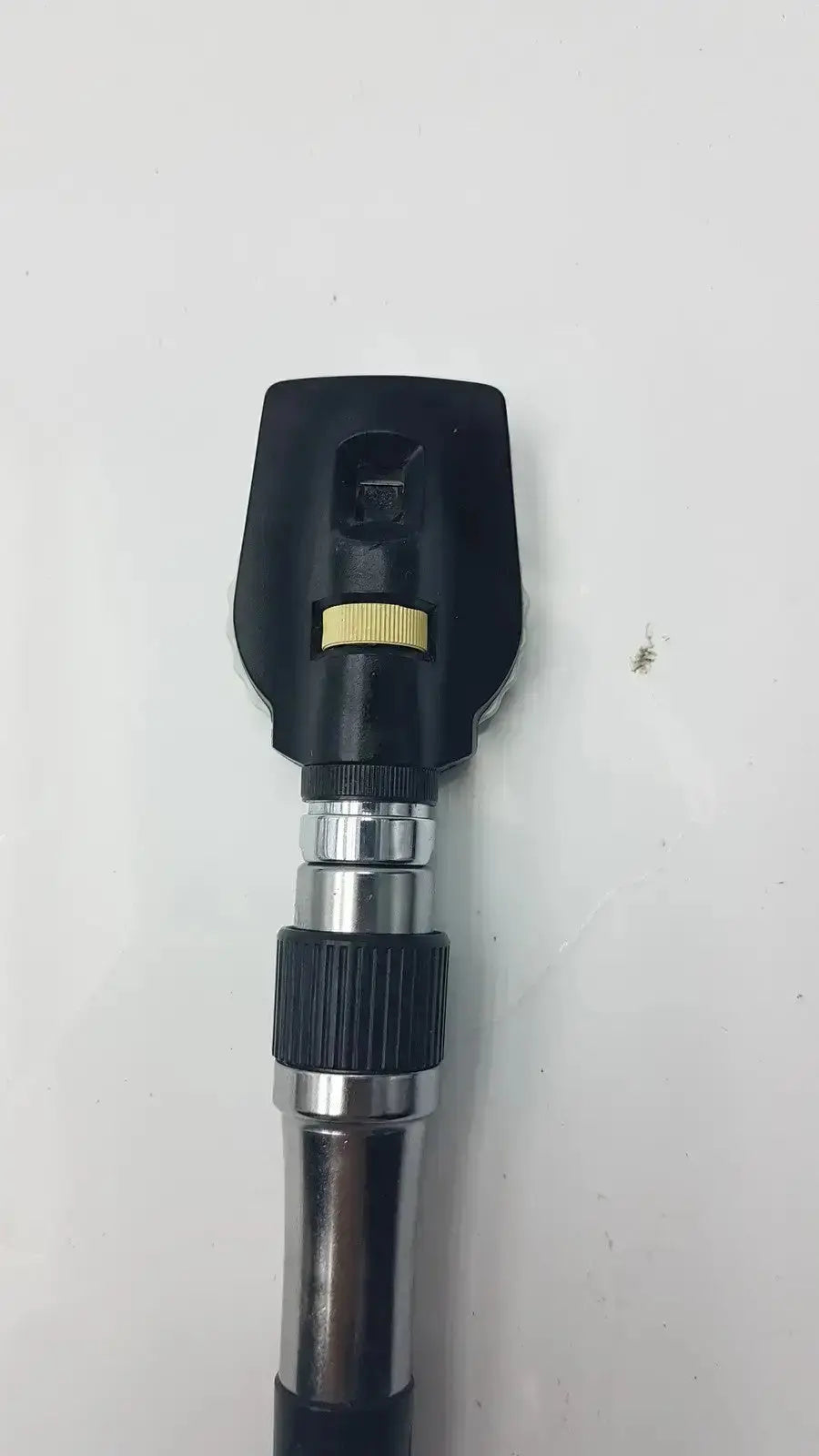 Black and silver Welch Allyn 3.5V ophthalmoscope head with yellow adjustment ring for hospital surplus use