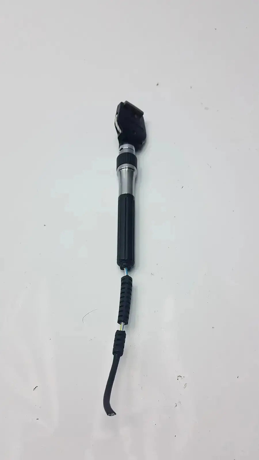 Welch allyn 3.5v ophthalmoscope head with black silver textured grip handle and flexible rubber cable from hospital surplus