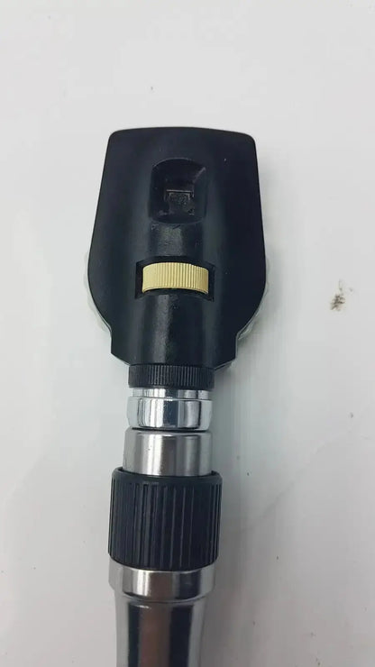 Welch Allyn 3.5V ophthalmoscope head in black and silver with yellow adjustment ring for hospital surplus use