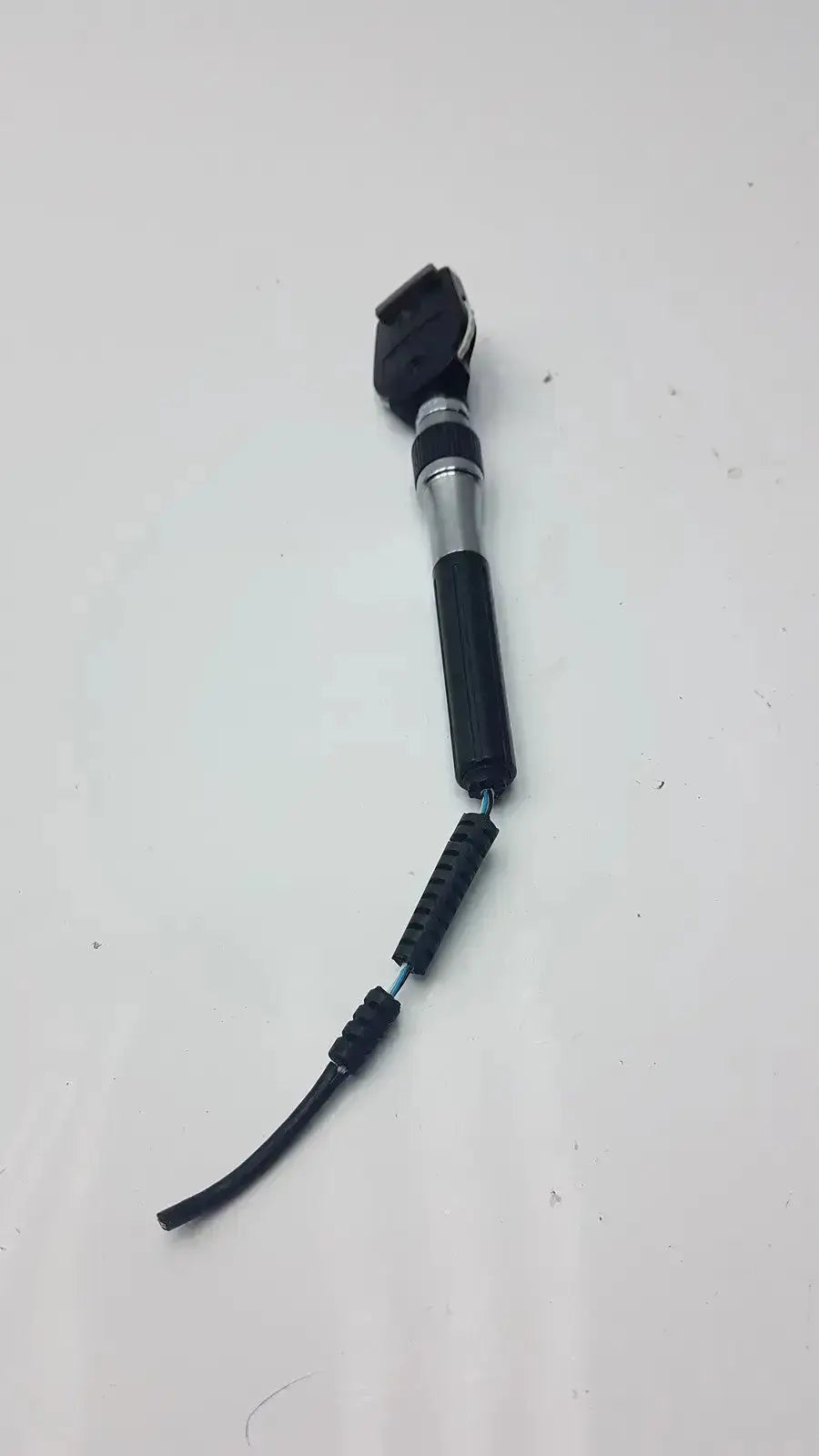 Welch Allyn ophthalmoscope head in black and silver with textured grip handle suitable for hospital surplus use