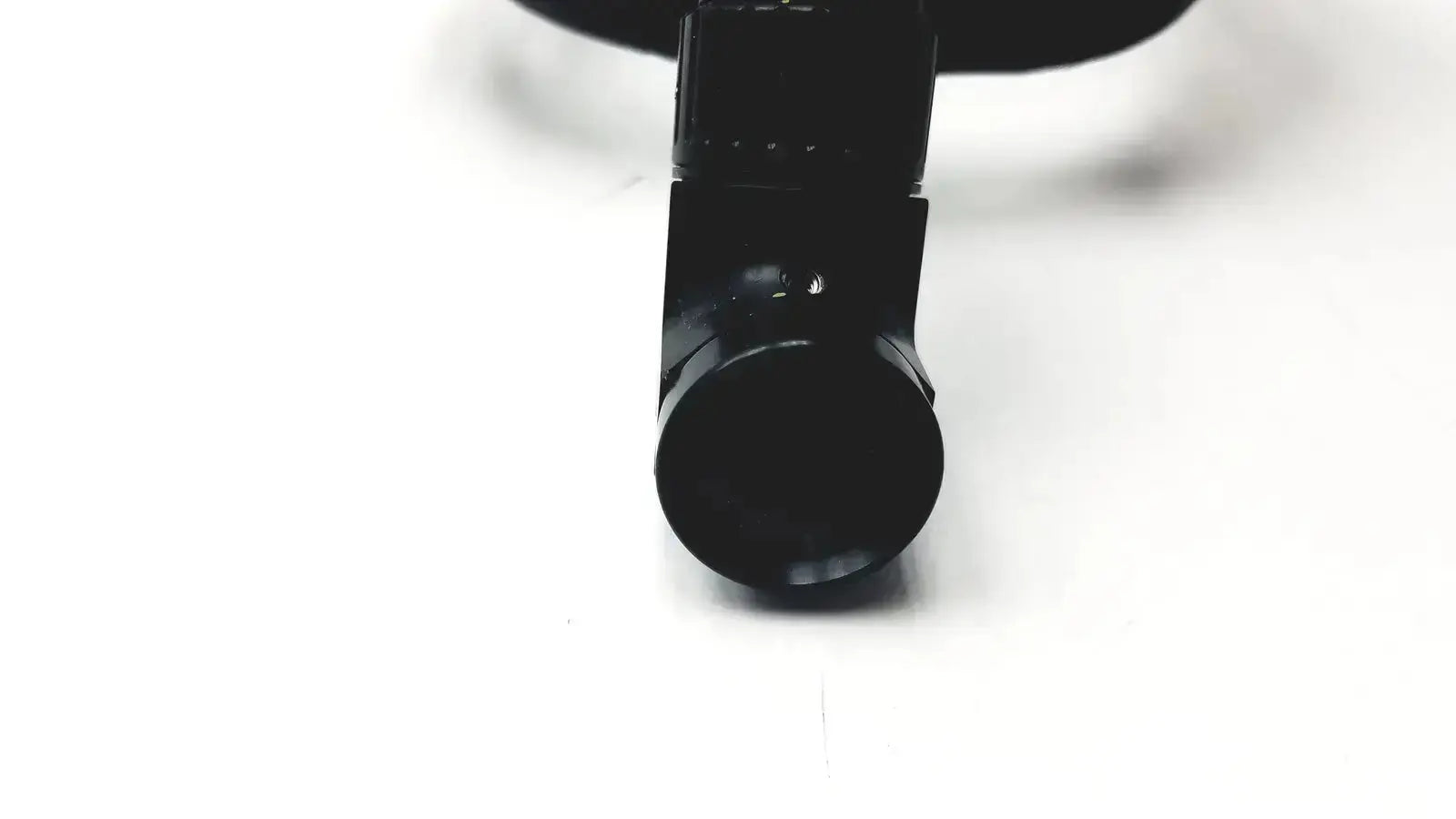 Black plastic camera lens mount on the back side of the welch allyn 49540 surgical headlight assy product