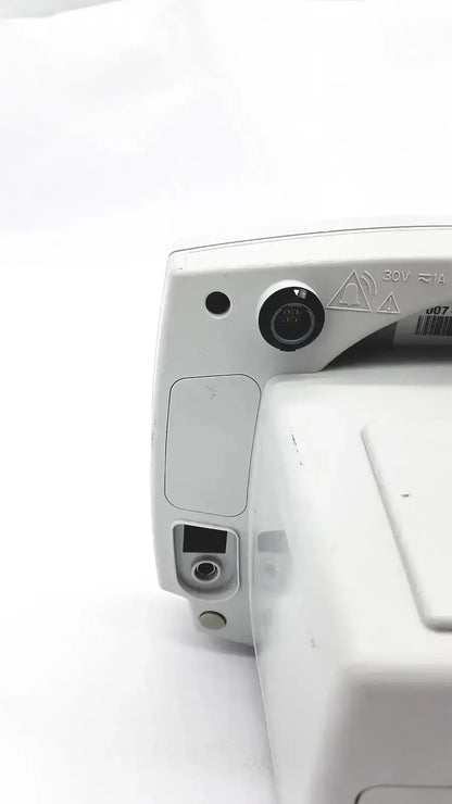 White plastic back panel of welch allyn 53000 series vital signs monitor with circular port and rectangular connector