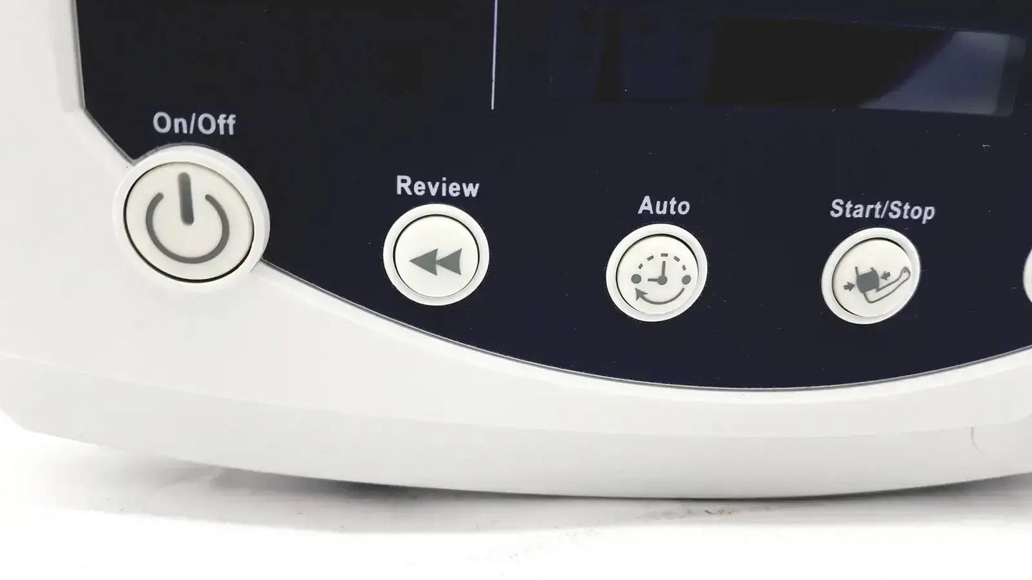 White plastic control panel with four circular buttons on/off review auto and start stop on welch allyn 53000 series vital signs monitor against dark navy background