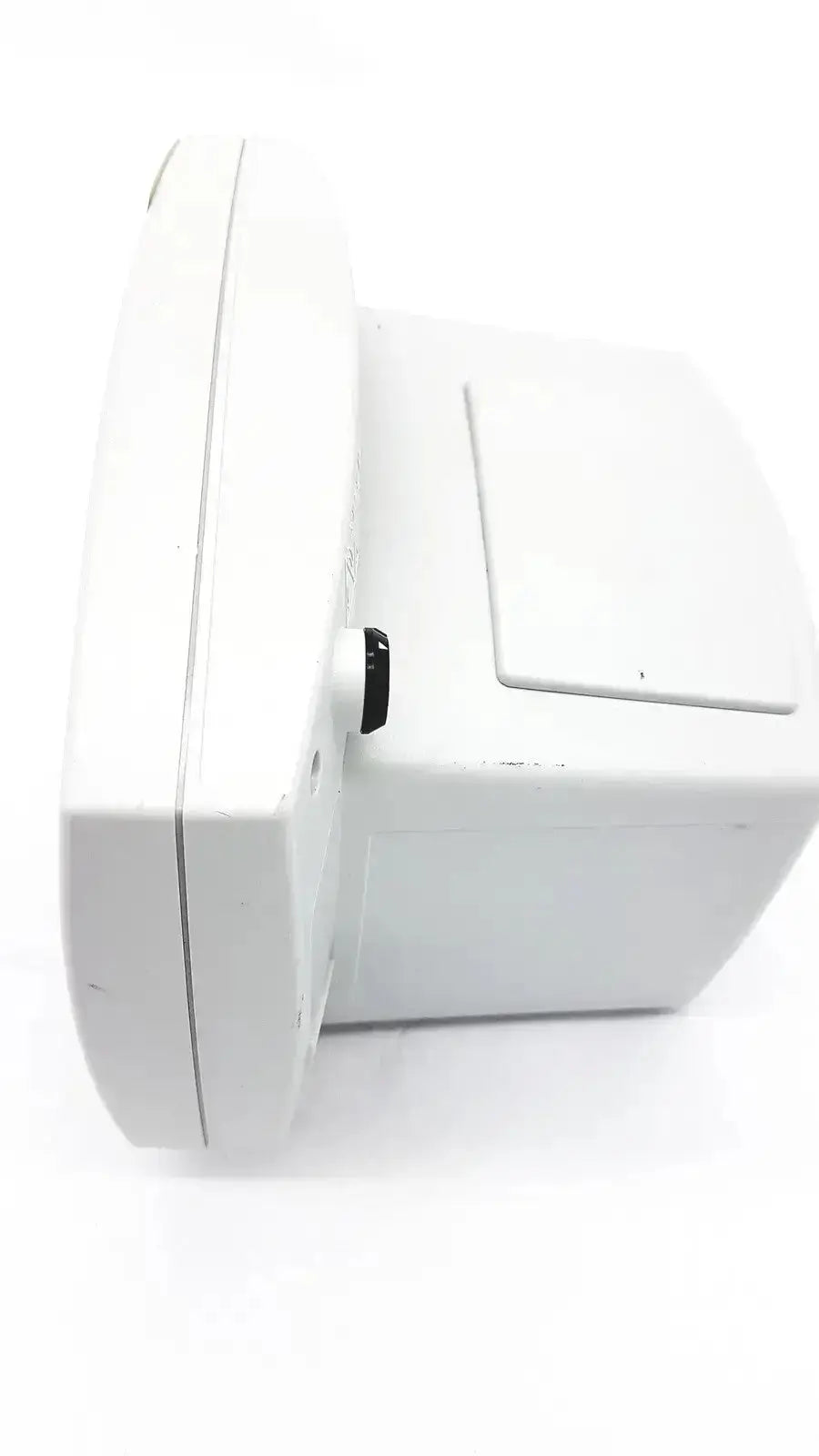 White plastic outdoor security camera with a small black button shown with welch allyn 53000 series vital signs monitor untested