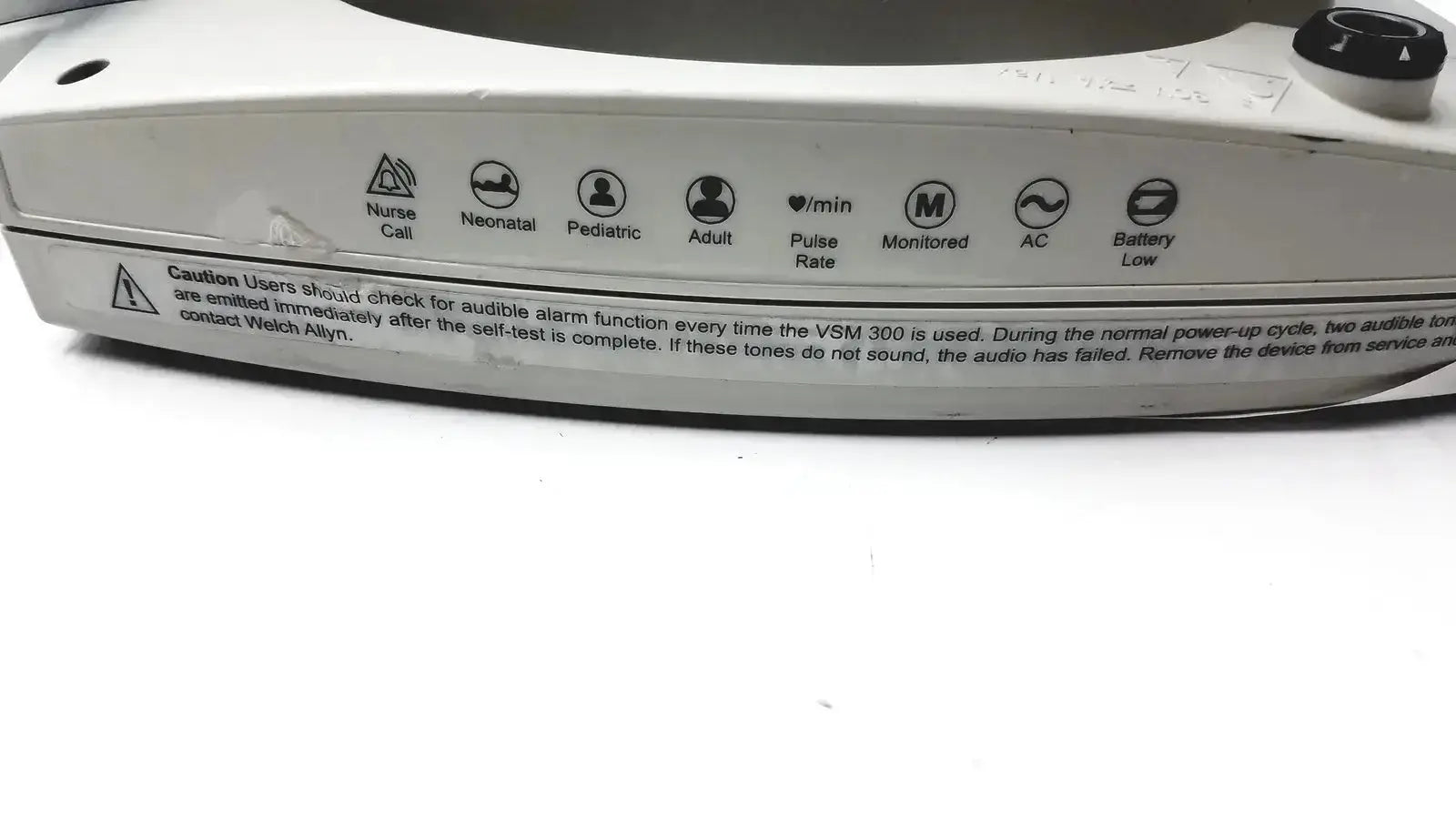 White plastic welch allyn 530t0 patient monitor with black knobs and labeled icons for pulse rate and power status