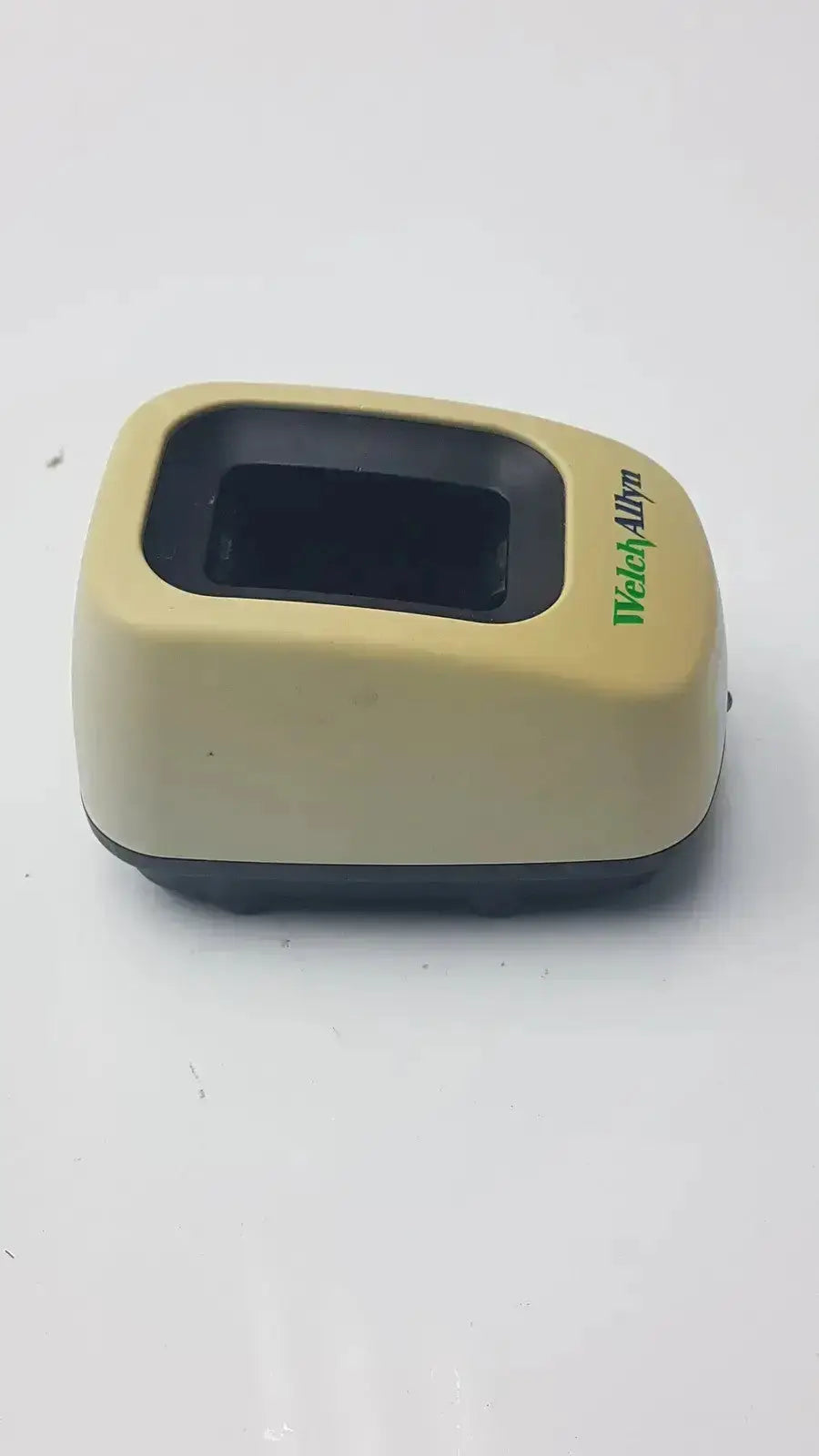 Beige plastic welch allyn 739 series charger with black fingerprint scanner and green watchallyn branding for medical use
