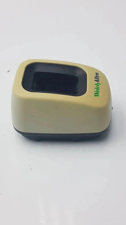 Beige plastic welch allyn 739 series charger with black fingerprint scanner and green watchallyn branding for medical use