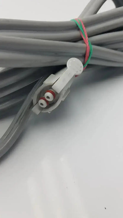 Gray welch allyn blood pressure hose with white locking connector and red white terminal screws bundled by green pink tie