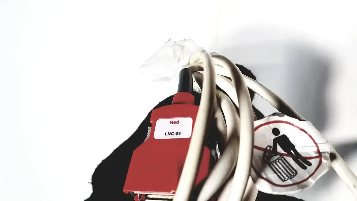 Red lnc-04 connector with black tip wrapped in white cables on the back of welch allyn connex vital signs monitor 6000 series