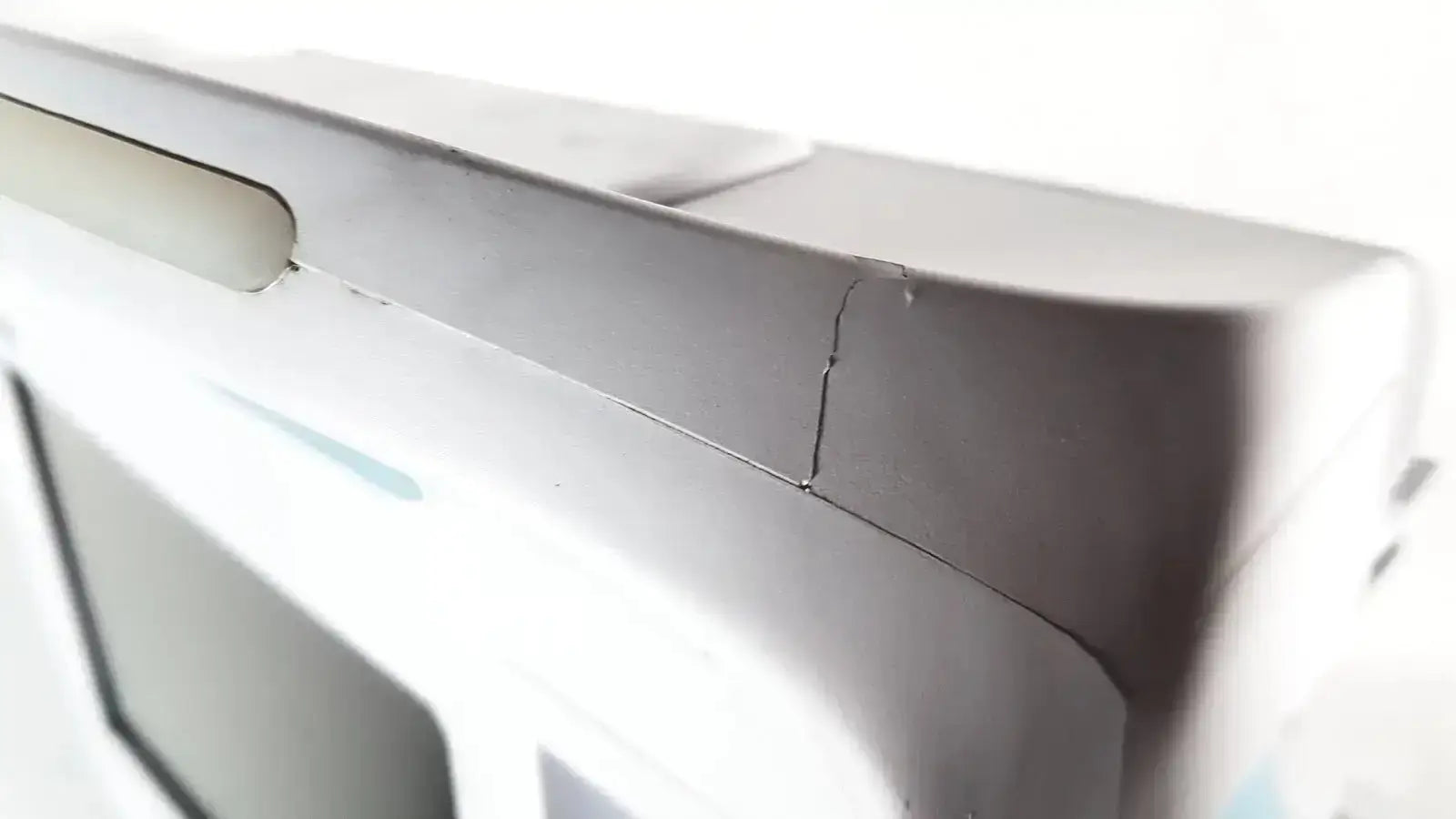 Gray plastic casing with visible seam and slight crack on the back side of welch allyn connex vital signs monitor 6000 series