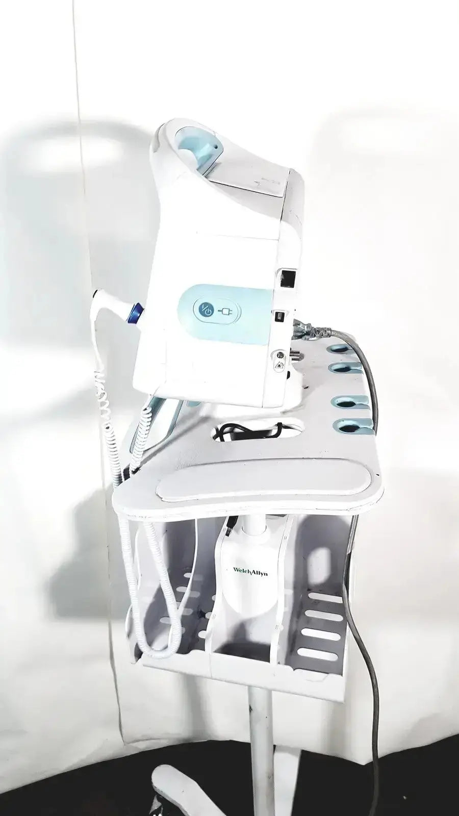 White and light blue welch allyn connex vital signs monitor 6000 series wireless mounted on adjustable stand cart