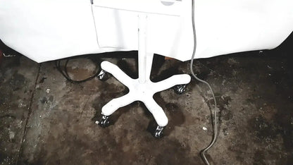 White five-star caster base with black wheels under an office chair for welch allyn connex vital signs monitor stand