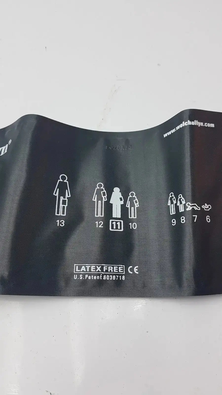 Black rubber blood pressure cuff with white sizing icons for adult use by Welch Allyn durable blood pressure cuff