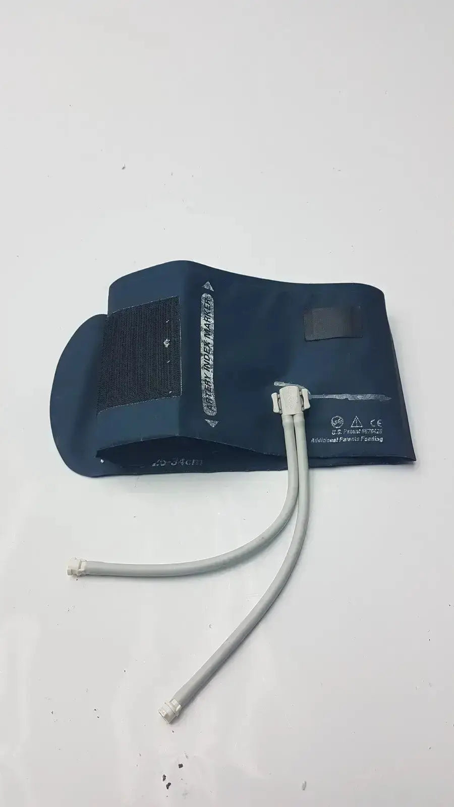 Dark blue welch allyn flexiport reusable blood pressure cuff with gray tubing and white connectors for adult use
