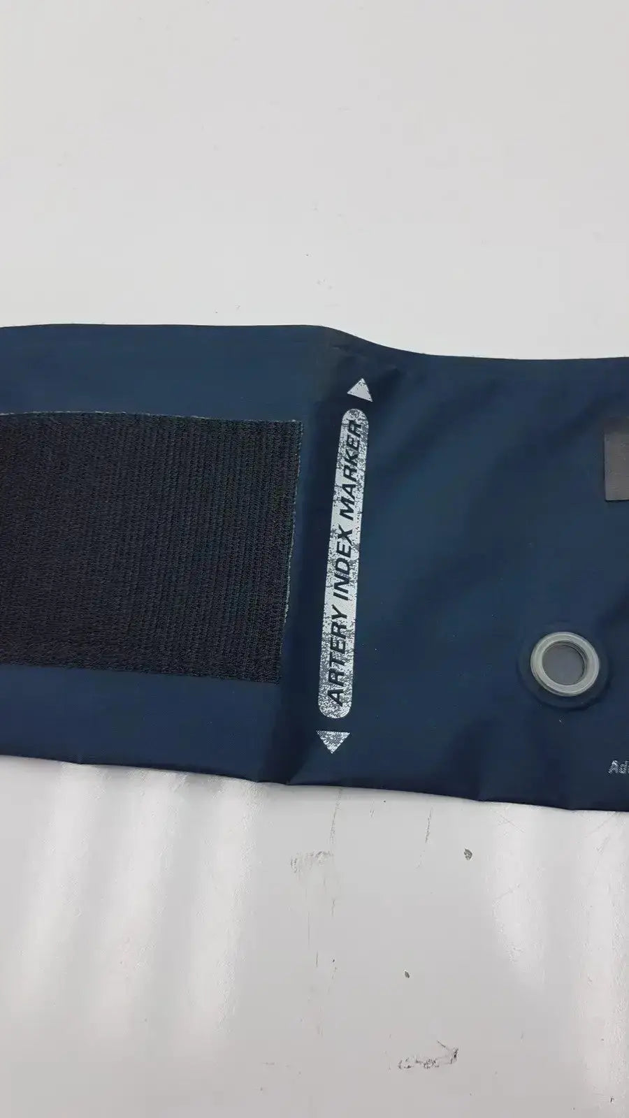 Dark blue welch allyn flexiport reusable blood pressure cuff adult 11 with black velcro strap and artery index marker label