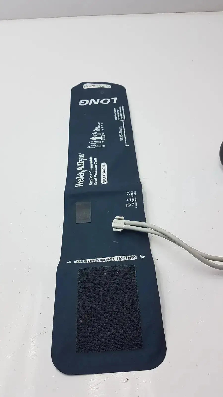 Dark blue flexible rubber welch allyn flexiport reusable blood pressure cuff with white connector and black velcro strap for adults
