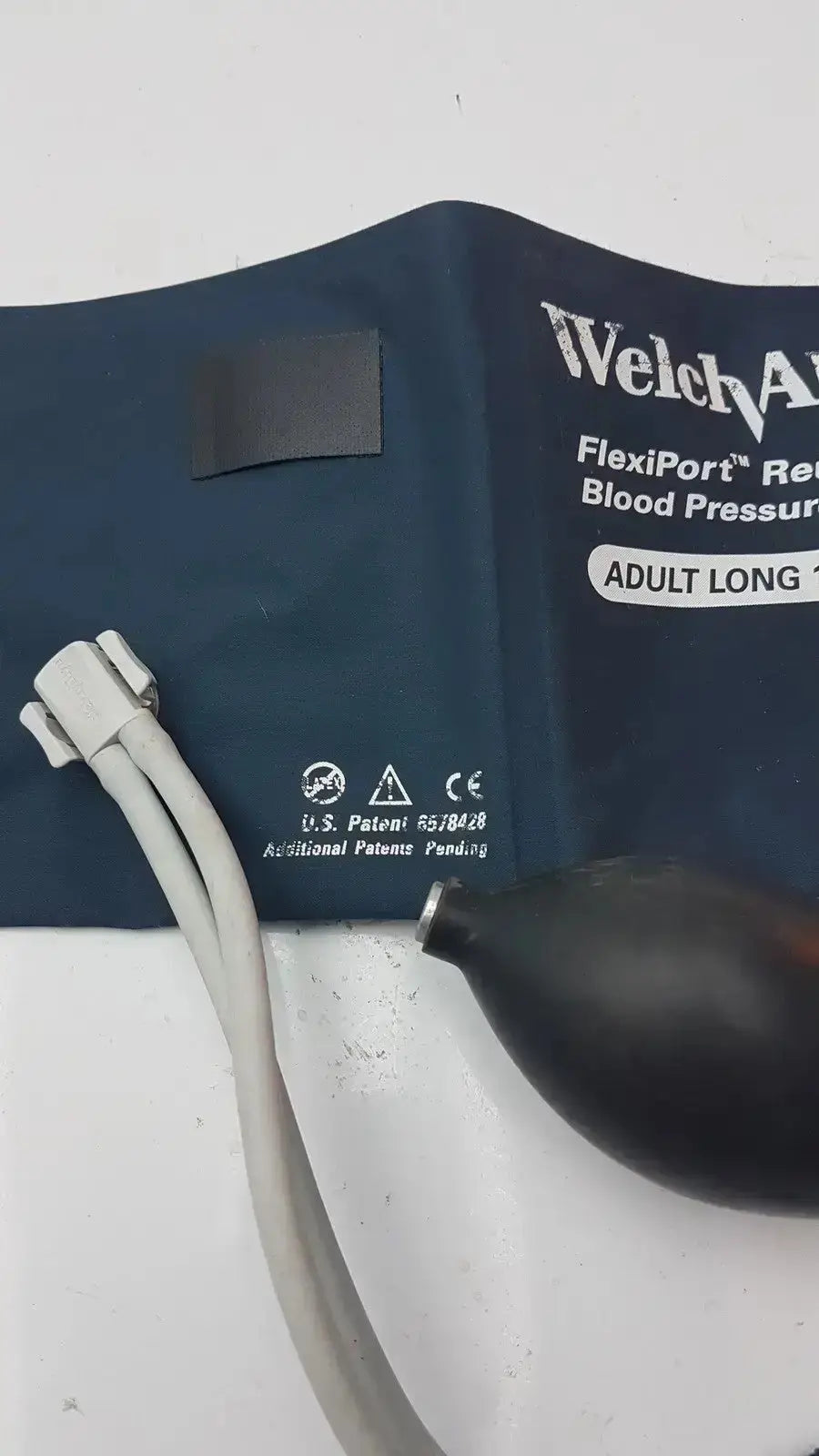 Dark blue welch allyn flexiport reusable adult long blood pressure cuff with black bulb and gray tubing for sizes 25-34cm
