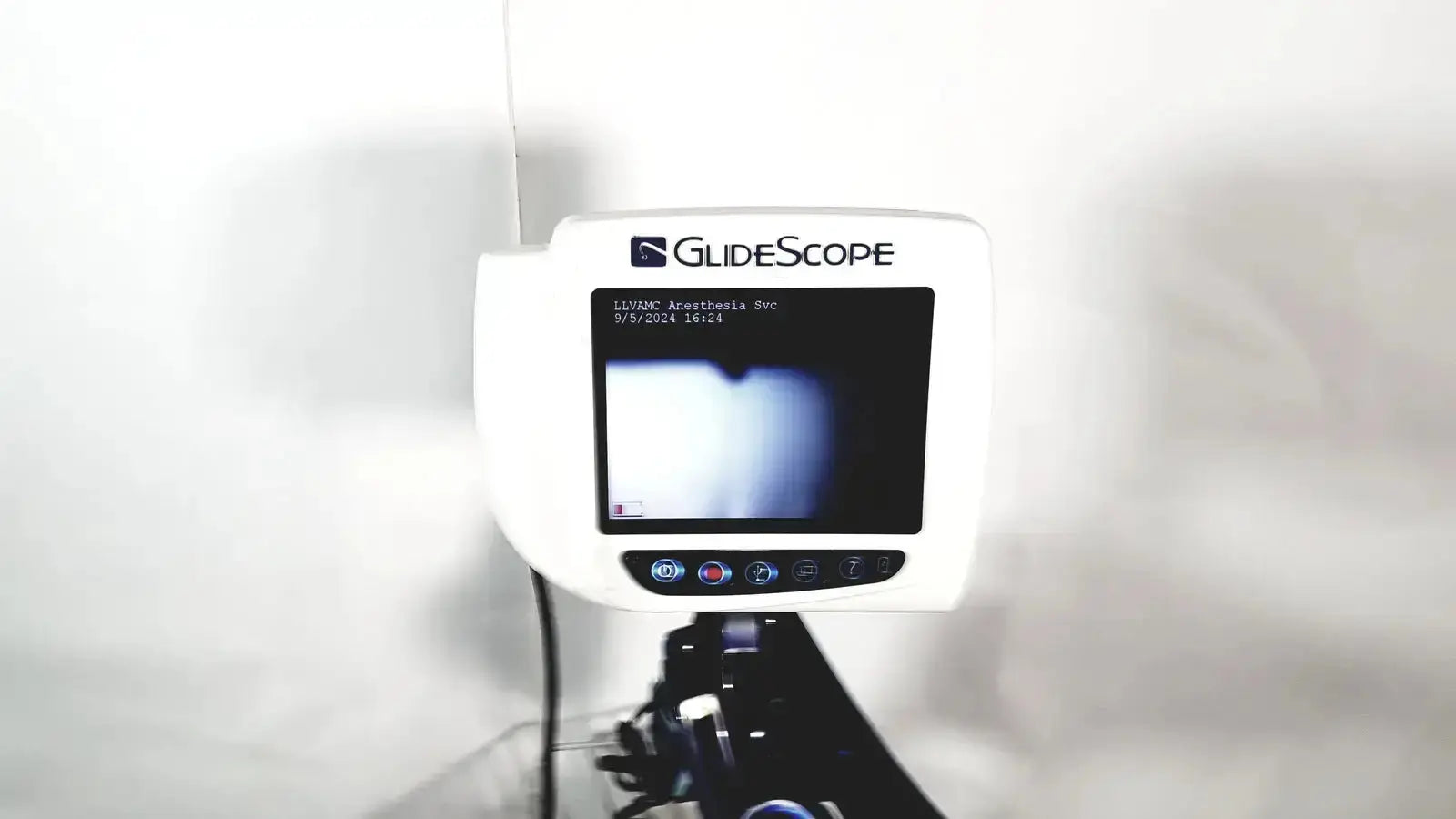 White Welch Allyn glidescope cobalt avl monitor with small screen and control buttons on cart and stand for medical use