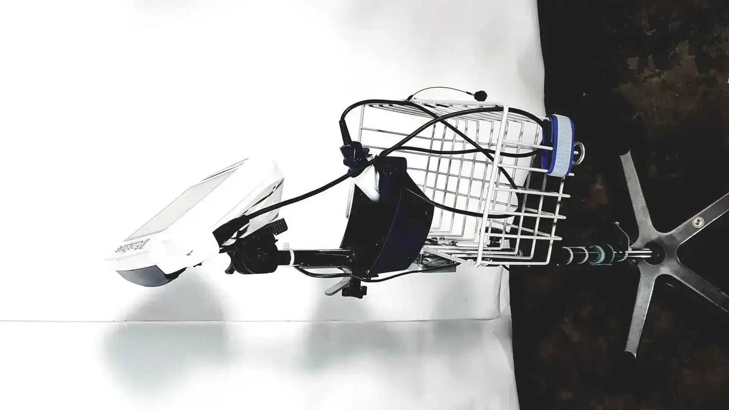 White wire basket mounted on bicycle handlebar with black cables and blue white cylinder in welch allyn glidescope cobalt avl