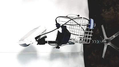 White wire basket mounted on bicycle handlebar with black cables and blue white cylinder in welch allyn glidescope cobalt avl