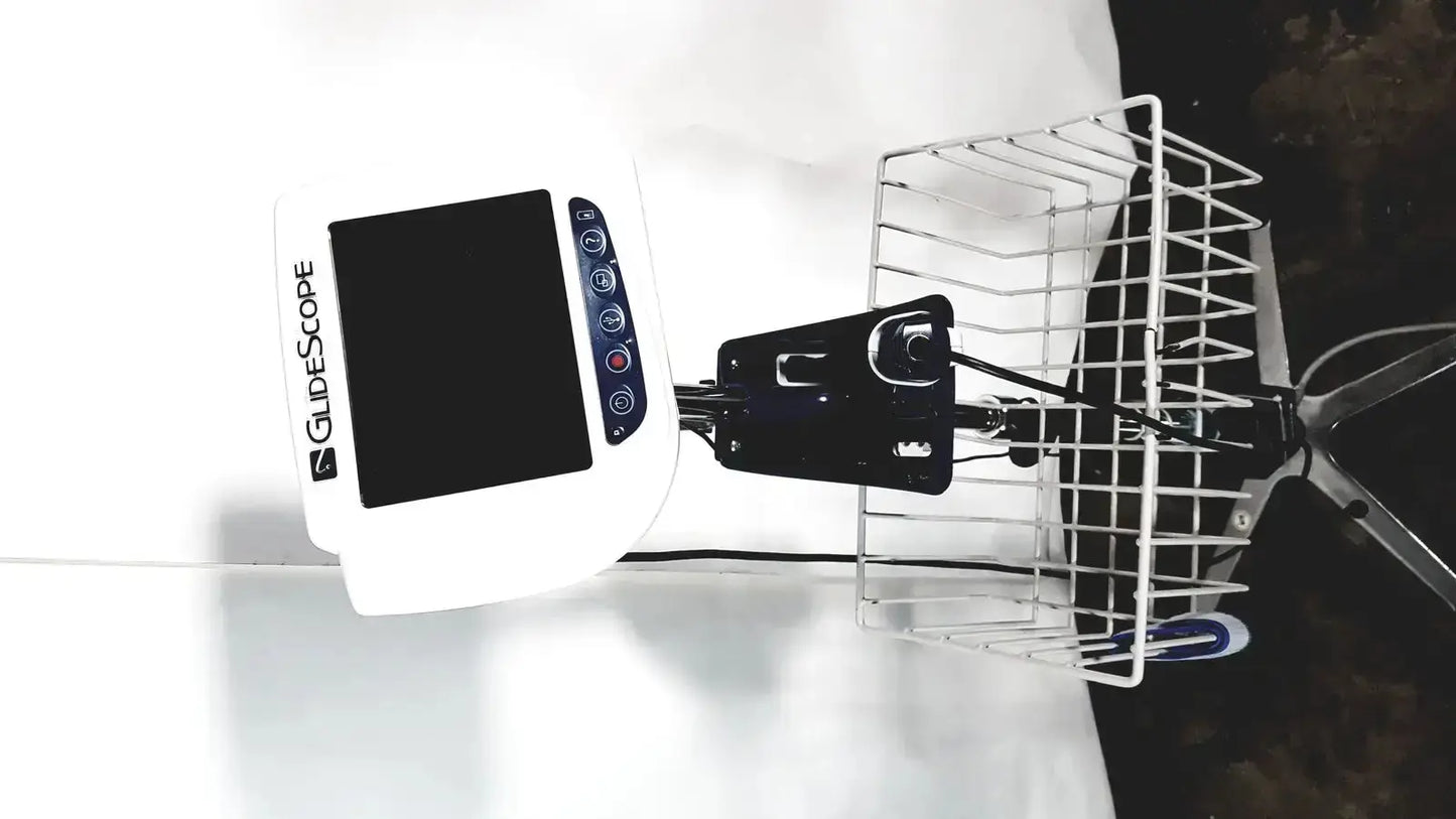 White Welch Allyn Glidescope Cobalt AVL monitor with black control buttons mounted on bicycle basket digital screen visible